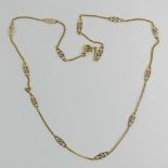 A 9ct gold necklace having thirteen pierced marquis shaped panels alternating with sections of curb