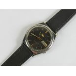 A Seiko 5 automatic daydate wristwatch having black dial with yellow metal hands,
