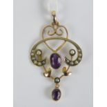 A delightful Edwardian 9ct gold amethyst and seed pearl pendant having open heart and floral design
