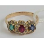 A ruby, emerald, sapphire and diamond cluster ring, the oval cut ruby,