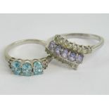 Two silver rings, one set with aquamarine size Q, one with purple and white stones size T.