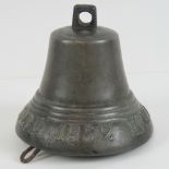 A bronze Russian bell bearing Cyrillic text and date "1852" 11.5cm Diameter.