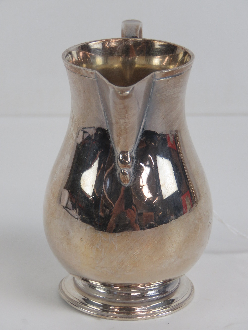 A silver jug hallmarked Birmingham 1962, standing 8.7cm high and weighing 4.485ozt. - Image 3 of 3