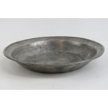 A heavy pewter dish having initials DC to base, measuring 31.5cm dia and weighing 1.634kg.