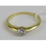 An 18ct gold diamond solitaire ring, the round cut brilliant diamond being approx 0.