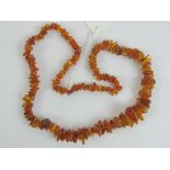 A Baltic amber necklace having graduated beads of various shapes, approx 67cm in length, 43.7g.