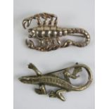 Two silver brooches, one in the form of a lizard stamped silver,