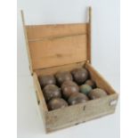 A vintage pine box containing a quantity of eight antique lignum vitae bowls, with jaque, a/f.