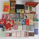 A large quantity of assorted packs of playing cards, bridge booklets,