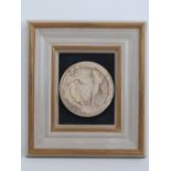 A framed and mounted marble roundel,