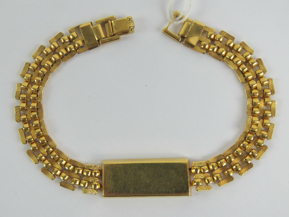 A yellow metal bracelet having 'ingot' style central panel marked 'African Gold Company',