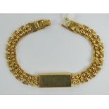 A yellow metal bracelet having 'ingot' style central panel marked 'African Gold Company',