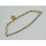 A 14ct gold tennis bracelet set with round cut white CZ and having heart charm upon, hallmarked 585,