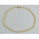 A string of individually knotted pearls with 9ct gold clasp,