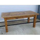 A contemporary solid pine kitchen table raised over substantial square cut legs, 6ft x 3ft.