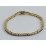 A 14ct gold and diamond articulated tennis bracelet having sixty-three round cut diamonds in white