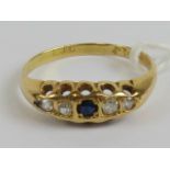 A vintage 18ct gold sapphire and diamond ring having carved head,
