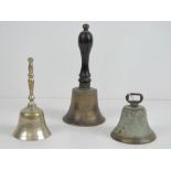 A brass bell having turned ebonised wood handle, standing 17cm high,