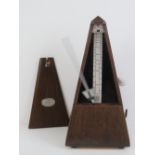 A pyramid metronome by Paquet standing 22cm high having wind up clockwork movement.