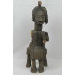 A late 19th / early 20th century Yoruba seated fertility figurine, a/f, 45cm high.