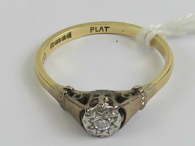 An 18ct gold and platinum diamond solitaire ring, illusion set diamond, hallmarked 18ct, size M-N,