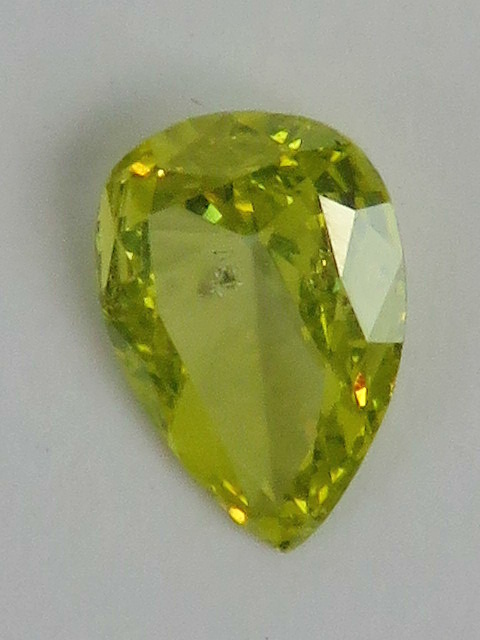 A 0.5ct canary yellow pear cut diamond, loose in protective case.