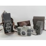 Three vintage cameras including Ferrania Primar 85 with leather case,