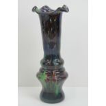 A Murano art glass vase having fluted rim in blues, greens and brown, standing 37cm high.