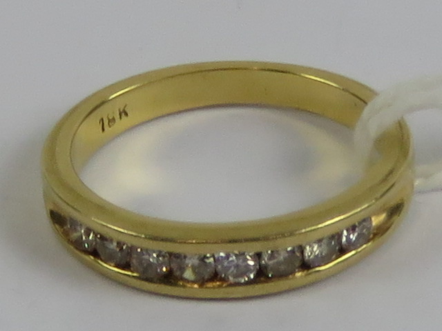 An 18ct gold and diamond half eternity ring having eight brilliant round cut diamonds in channel