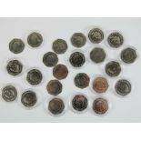 A quantity of Beatrix Potter Peter Rabbit commemorative 50p coins, some in protective plastic pods.
