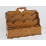 A Victorian four sectional oak desk letter rack, 30cm wide.