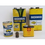 A Shell gear oil can together with three Duckhams motor oil cans and an 'Original Primus' can.