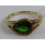A 9ct gold ring having teardrop shaped green Russian diopside in wrap around and single claw