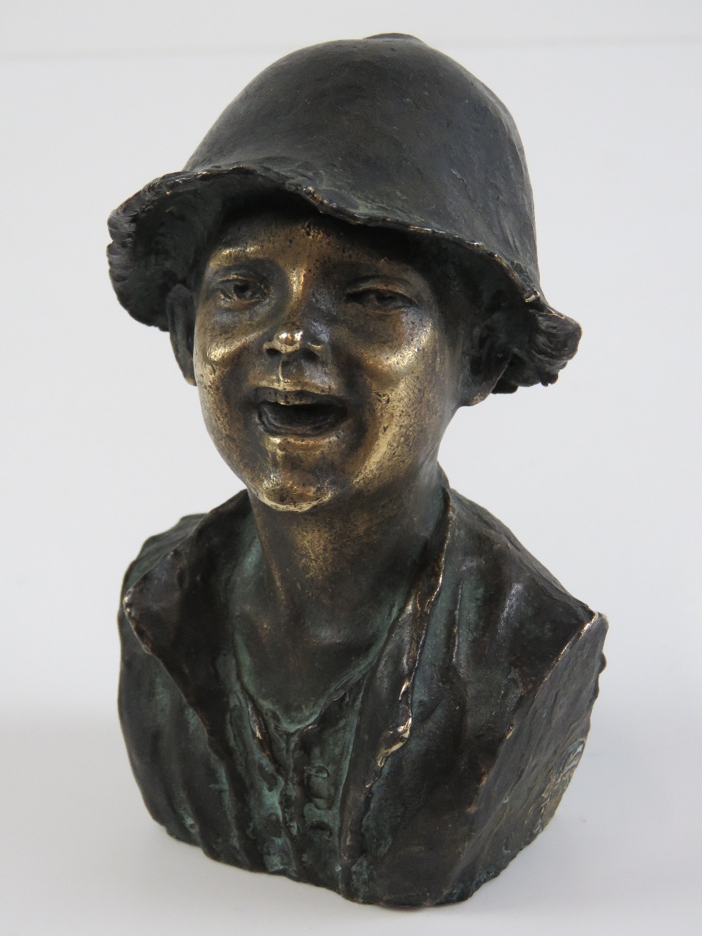 A bronze bust of a laughing child, Signe