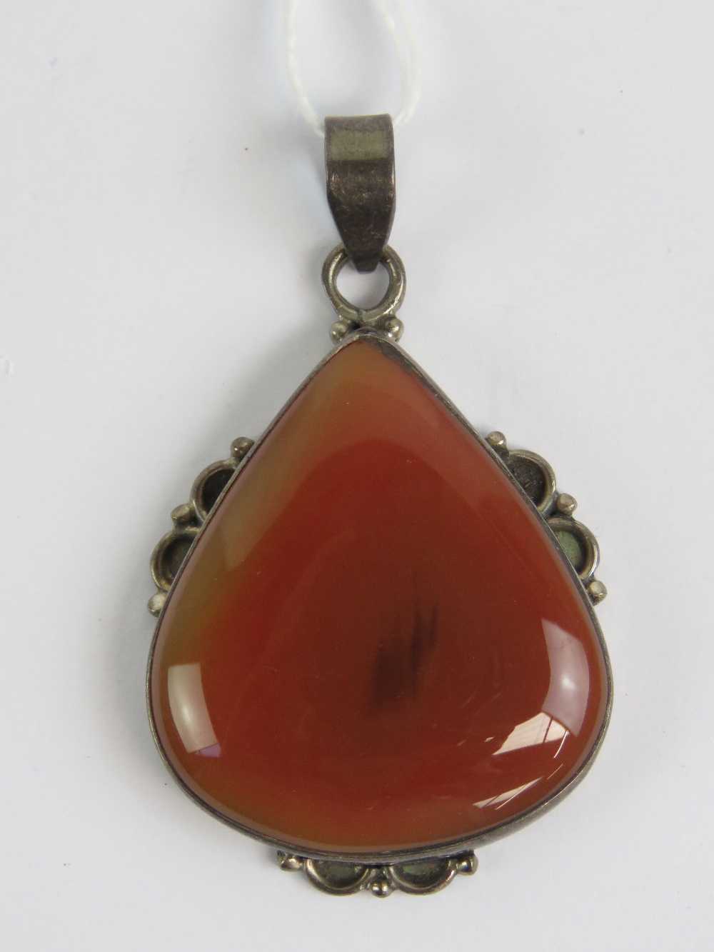 A large silver and carnelian pendant, st