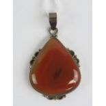A large silver and carnelian pendant, st