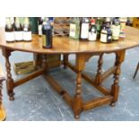 A GOOD QUALITY BESPOKE OAK LARGE GATELEG DINING TABLE ON TURNED SUPPORTS UNITED BY STRETCHERS, THE