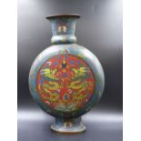 A CHINESE BLUE GROUND CLOISONNE MOON FLASK, THE RED GROUND ROUNDELS TO EACH SIDE WITH PAIRS OF