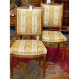 A PAIR OF FRENCH LOUIS XVI STYLE CARVED WALNUT SALON CHAIRS.
