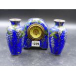A JAPANESE CLOISONNE BLUE GROUND CLOCK GARNITURE, THE CLOCK CASE AND FLANKING VASES DECORATED WITH