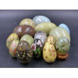 A COLLECTION OF FIFTEEN STONE LACQUER AND CLOISONNE EGG HAND COOLERS, ONE WITH WOOD STAND.