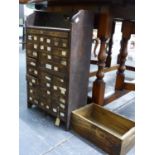 A NEST OF COLLECTOR'S DRAWERS AND A HORSESHOE NAIL CRATE.