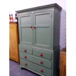 AN EARLY 19th.C.COUNTRY PINE HOUSEMAID'S CUPBOARD WITH TWIN PANELLED DOORS OVER FOUR DRAWER BASE.