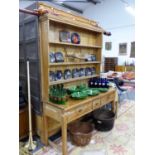 A LATE VICTORIAN PINE DRESSER WITH ASSOCIATED PLATE RACK OVER THREE DRAWERS ON SQUARE TAPERED