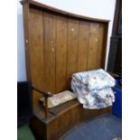 AN EARLY 19th.C.PINE CURVED BACK HALL SETTLE WITH BOX SEAT. W.153 x H.171cms.