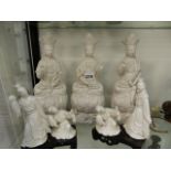 THREE BLANC DE CHINE FIGURESOF GUANYAN ENTHRONED, H.30.5cms AND TWO PAIRS OF LADIES DANCING ON