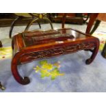 A CHINESE CARVED HARDWOOD LOW TABLE WITH INCURVED SCROLLED LEGS AND FOLIATE PANELS. L.88cms.