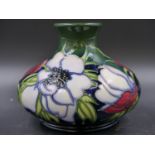 A 2003 DATED MOORCROFT VASE SLIP TRAILED WITH FLOWERS ON A SEA GREEN GROUND. H.11cms.