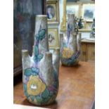 A PAIR OF UNUSUAL AMPHORA ROSE DECORATED POTTERY VASES. H.40cms.