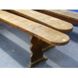 A PAIR OF LARGE CONTINENTAL FRUITWOOD FORMS OR BENCHES WITH PANEL END SUPPORTS. L.310 x W.22 x H.